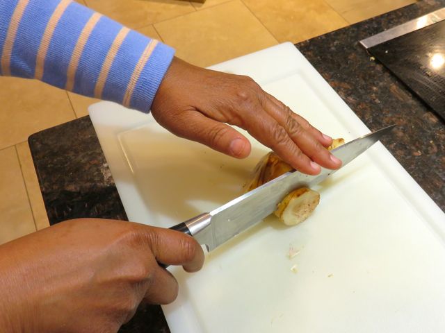 Insert knife partially into root, lift then whack down firmly.